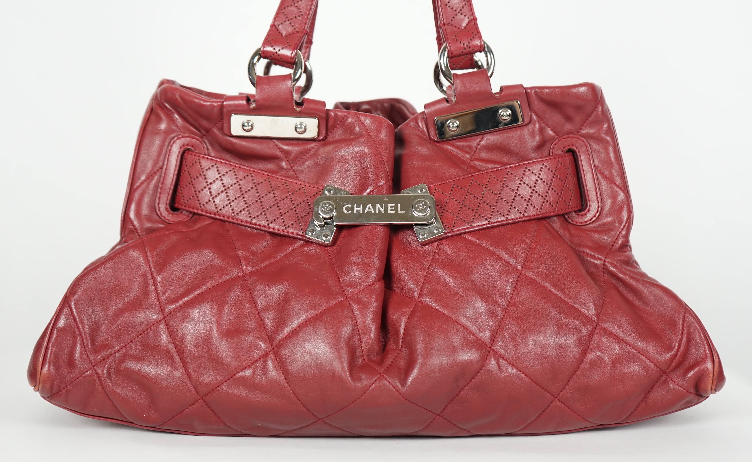 A Chanel burgundy leather buckled handle bag, with dust bag, width 45cm, height: 24.5cm, height overall 44cm, depth 16.5cm, Please note this lot attracts an additional import tax of 20% on the hammer price